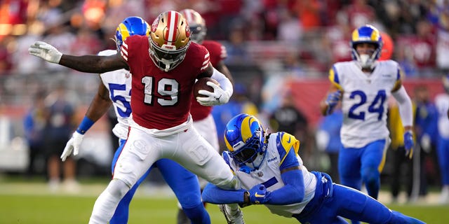 San Francisco 49ers wide receiver Devo Samuel #19 rushes for a touchdown after breaking a tackle by Los Angeles Rams cornerback Jalen Ramsey #5 on Oct. 3, 2022 at Levi's Stadium in Santa Clara, Calif.