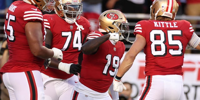Wide receiver Deebo Samuel #19 of the San Francisco 49ers celebrates with teammates after rushing for a touchdown against the Los Angeles Rams during the second quarter at Levi's Stadium on Oct. 3, 2022 in Santa Clara, California.