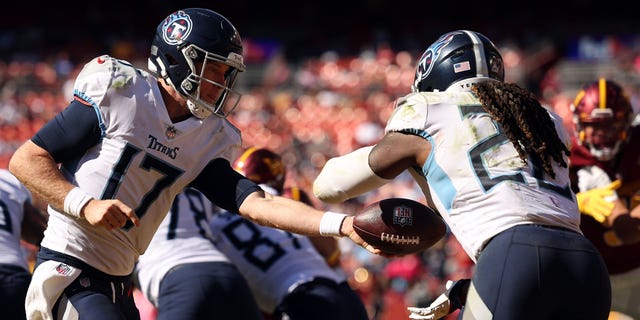 Ryan Tannehill #17 of the Tennessee Titans throws the ball to Derrick Henry #22 of the Tennessee Titans during the second half against the Washington Commanders at FedExField on October 9, 2022 in Landover, Maryland.