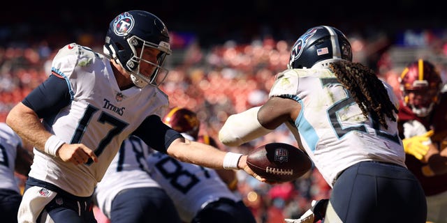 Ryan Tannehill #17 of the Tennessee Titans hands the ball off to Derrick Henry #22 of the Tennessee Titans during the second half against the Washington Commanders at FedExField on October 09, 2022 in Landover, Maryland.