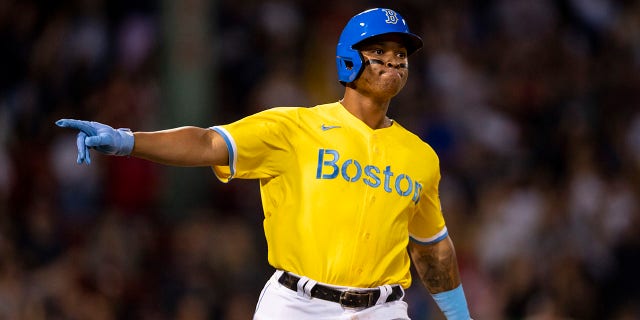 Rafael Devers #11 of the Boston Red Sox reacts after hitting a three-run home run during the sixth inning of a game against the New York Yankees on September 24, 2021 at Fenway Park in Boston, Massachusetts.