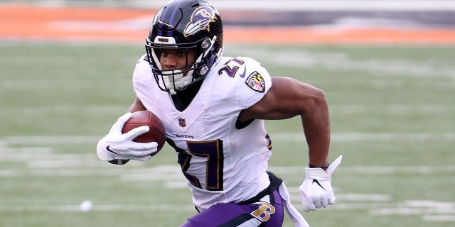 J.K. Dobbins #27 of the Baltimore Ravens runs with the ball against the Cincinnati Bengals at Paul Brown Stadium on Jan. 3, 2021, in Cincinnati, Ohio.