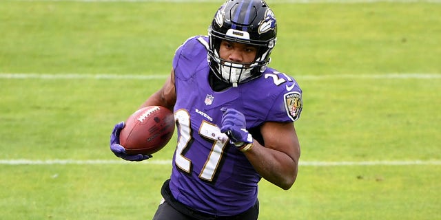 Running back J.K. Dobbins #27 of the Baltimore Ravens runs against the Jacksonville Jaguars during the first half at M&T Bank Stadium on Dec. 20, 2020, in Baltimore, Maryland.