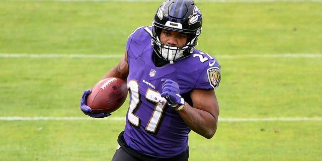 Baltimore Ravens running back JK Dobbins #27 takes on the Jacksonville Jaguars on December 20, 2020 at M&T Bank Stadium in Baltimore, Maryland.