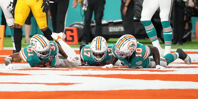 Raheem Mostert #31 of the Miami Dolphins celebrates his touchdown with teammates during the first quarter against the Pittsburgh Steelers at Hard Rock Stadium on October 23, 2022, in Miami Gardens, Florida. 