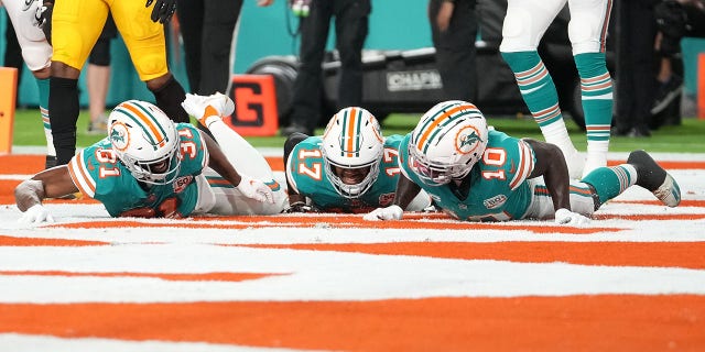 Raheem Mostert #31 of the Miami Dolphins celebrates his touchdown with teammates during the first quarter against the Pittsburgh Steelers at Hard Rock Stadium on October 23, 2022, in Miami Gardens, Florida.