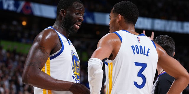 Draymond Green, #23, and Jordan Poole, #3 of the Golden State Warriors, talk during Round 1 Game 4 of the 2022 NBA Playoffs on April 24, 2022 at the Ball Arena in Denver.