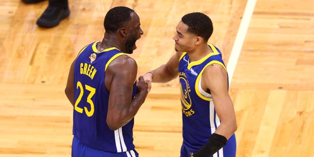 Jordan Pool #3 and Draymond Green #23 of the Golden State Warriors celebrate during the fourth quarter in Game Six of the 2022 NBA Finals against the Boston Celtics at TD Garden on June 16, 2022 in Boston, Massachusetts. 
