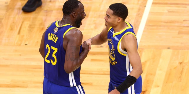 Jordan Poole #3 and Draymond Green #23 of the Golden State Warriors celebrate against the Boston Celtics during the fourth quarter in Game Six of the 2022 NBA Finals at TD Garden on June 16, 2022, in Boston, Massachusetts. 