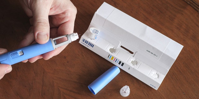 Man prepares the Semaglutide Ozempic injection, which is intended to control blood sugar levels.