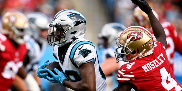 Terrace Marshall Jr. of the Carolina Panthers is tackled by Emmanuel Moseley (4) of the San Francisco 49ers during the second quarter at Bank of America Stadium on Oct. 9, 2022, in Charlotte, North Carolina.
