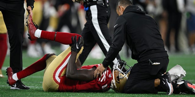 Emmanuel Moseley of the San Francisco 49ers holds his knee during the second half against the Carolina Panthers at Bank of America Stadium on Oct. 9, 2022, in Charlotte, North Carolina.