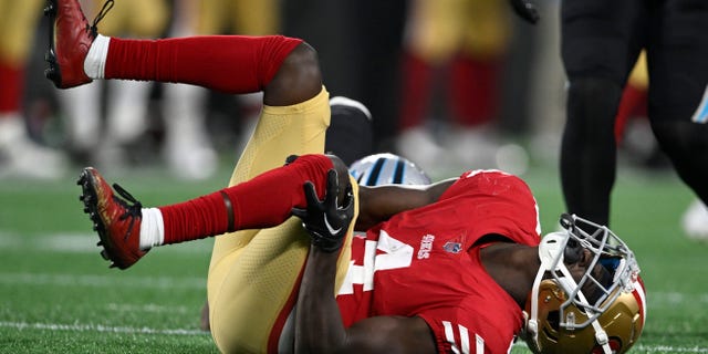 Emmanuel Moseley of the San Francisco 49ers holds his knee during the second half against the Carolina Panthers at Bank of America Stadium on Oct. 9, 2022, in Charlotte, North Carolina.