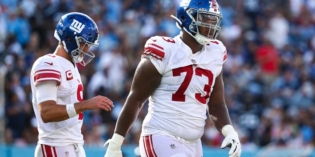 Evan Neal #73 of the New York Giants walks to the bench during an NFL football game against the Tennessee Titans at Nissan Stadium on September 11, 2022, in Nashville, Tennessee.