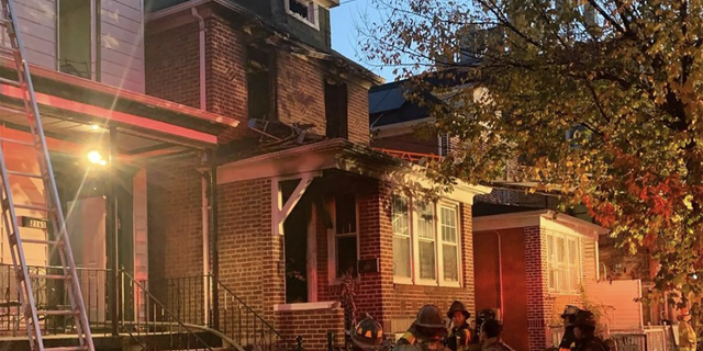 Firefighters observe the home after putting out the flames. 