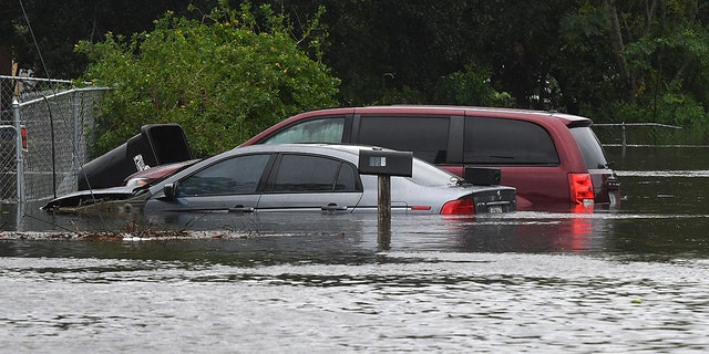 Cars are shown submerged in a flooded street in the aftermath of Hurricane Ian on Sept. 29, 2022 in Orlando, Florida. 