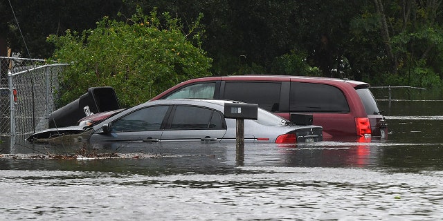 Cars are shown submerged in a flooded street in the aftermath of Hurricane Ian on Sept. 29, 2022 in Orlando, Florida. 