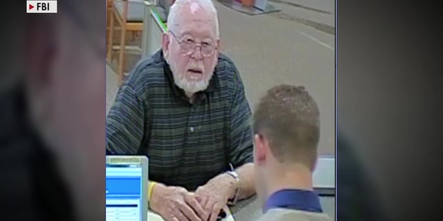 Donald Griffith, who had $750,000 stolen from him in a romance scam, deposits money at a bank teller.