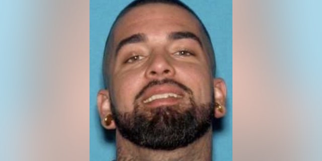 Garrett Cole, 31, was arrested on an outstanding warrant for murder, kidnapping and robbery, authorities said.