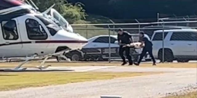 Georgia law enforcement agencies prepare to board K9 Figo on the helicopter after he was shot multiple times on Friday.