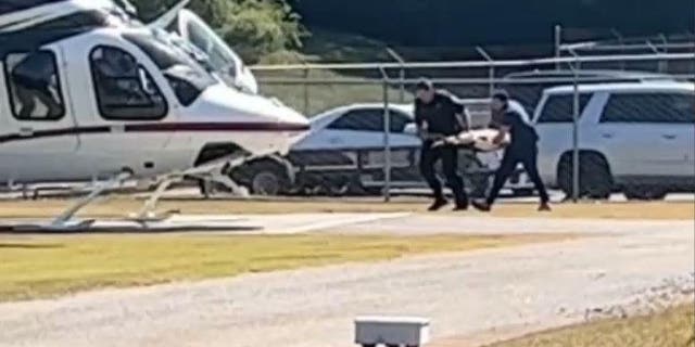 Georgia law enforcement agencies prepare to board K9 Figo on the helicopter after he was shot multiple times on Friday.