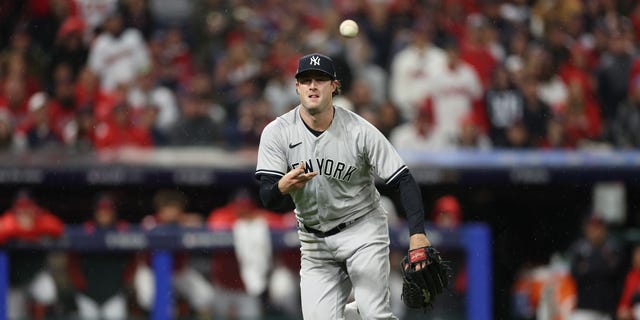 Gerrit Cole #45 of the New York Yankees throws the ball to first base against the Cleveland Guardians during the fifth inning in game four of the American League Division Series at Progressive Field on October 16, 2022 in Cleveland, Ohio.