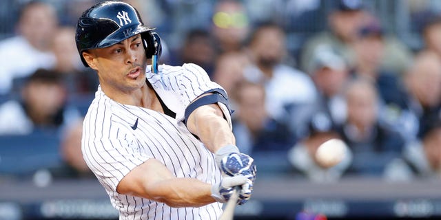 Giancarlo Stanton of the New York Yankees hits a three-run home run against the Cleveland Guardians during the first inning in Game 5 of an American League Division Series at Yankee Stadium Oct. 18, 2022, in New York.