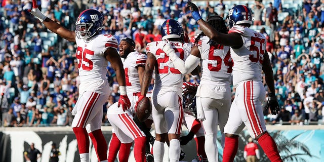 The New York Giants defense celebrates after a fourth quarter stoppage against the Jacksonville Jaguars at TIAA Bank Field on October 23, 2022 in Jacksonville, Florida.