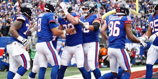 New York Giants teammates celebrate with Daniel Jones (8) after a touchdown during the first quarter against the Chicago Bears at MetLife Stadium on Oct. 2, 2022, in East Rutherford, New Jersey.