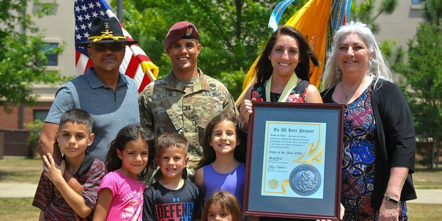 Army Capt. Gilberto De Leon poses for a photo with his family. De Leon was selected for promotion to major in 2019, but his promotion packet stalled because of a misleading flag on his record.