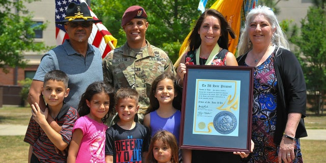Army Captain Gilberto De Leon poses for a photo with his family. De León was selected to be promoted to Major in 2019, but his promotion package stalled due to a misleading flag on his record.