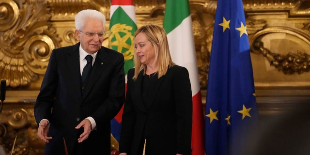 Italian President Sergio Mattarella is flanked by newly appointed Italian Premier Giorgia Meloni during the swearing in ceremony at Quirinal presidential palace in Rome, Saturday, Oct. 22, 2022, as Italy's first far-right-led government since the end of World War II takes office.