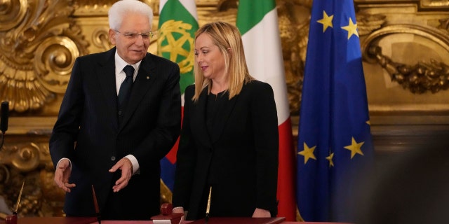 Italian President Sergio Mattarella is flanked by newly appointed Italian Premier Giorgia Meloni during the swearing in ceremony at Quirinal presidential palace in Rome, Saturday, Oct. 22, 2022, as Italy's first far-right-led government since the end of World War II takes office.