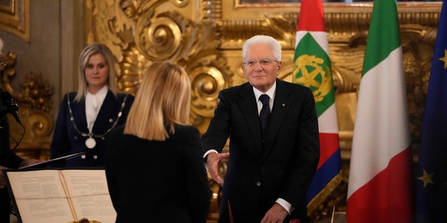 Italian President Sergio Mattarella shakes hand to the newly appointed Italian Premier Giorgia Meloni during the swearing in ceremony at Quirinal presidential palace in Rome, Saturday, Oct. 22, 2022, as Italy's first far-right-led government since the end of World War II takes office.