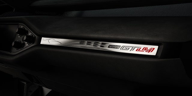 A commemorative dash plaque contains material from the engine of the third-place GT at the 2016 24 Hours of Le Mans.