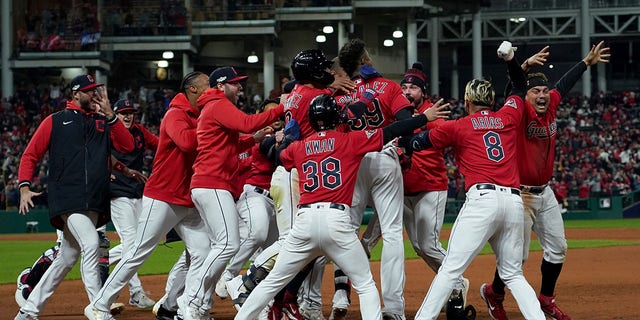 Oscar Gonzalez #39 of the Cleveland Guardians celebrates with his team after hitting a two run single during the ninth inning against the New York Yankees in game three of the American League Division Series at Progressive Field on October 15, 2022 in Cleveland, Ohio.