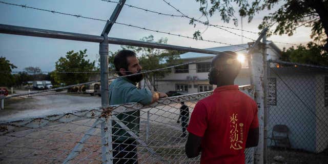 A manager of Christian Aid Ministries headquarters (left) talks to a Haitian worker (right) in Titanyen, north of Port-au-Prince, Haiti, on November 21, 2021.