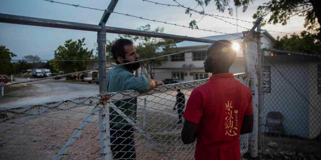 A manager of Christian Aid Ministries headquarters (left) talks to a Haitian worker (right) in Titanyen, north of Port-au-Prince, Haiti, on November 21, 2021.