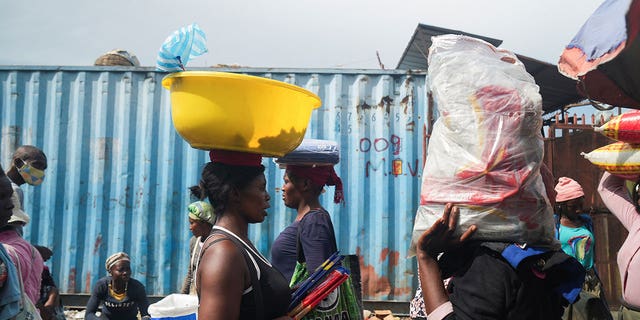 People stock up on food at a market amid shortages of water, cooking gas and other items in Port-au-Prince, Haiti, on Sept. 17, 2022. 