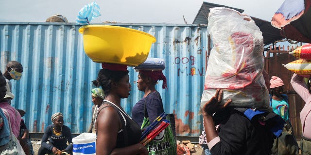 People stock up on food at a market amid shortages of water, cooking gas and other items in Port-au-Prince, Haiti, on Sept. 17, 2022.