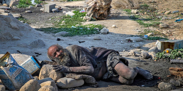 Amou Haji (uncle Haji) lies on the ground on the outskirts of the village of Dezhgah in the Dehram district of the southwestern Iranian Fars province, on December 28, 2018. - Believed to be the worlds dirtiest man, villagers say that Haji's leather-like skin hasn't touched soap and water for more than sixty years. They believe that he decided to live in isolation after suffering from an emotional setback in his youth. (Photo by - / AFP) (Photo by -/AFP via Getty Images)