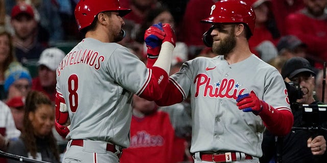 Philadelphia Phillies' Bryce Harper celebrates with Nick Castellanos (8) after Harper hit a solo home run against the St. Louis Cardinals during the second inning in Game 2 of an NL wild-card baseball playoff series, Saturday, Oct. 8, 2022, in St. Louis.