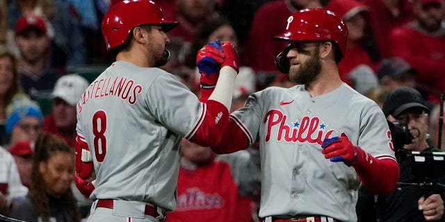 Philadelphia Phillies' Bryce Harper celebrates with Nick Castellanos (8) after Harper hit a solo home run against the St. Louis Cardinals during the second inning in Game 2 of an NL wild-card baseball playoff series, Saturday, Oct. 8, 2022, in St. Louis.