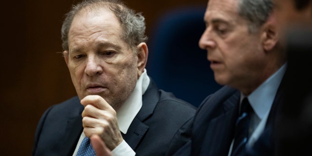 Harvey Weinstein interacts with his attorney Mark Werksman in court in Los Angeles on Tuesday, Oct. 4 2022.