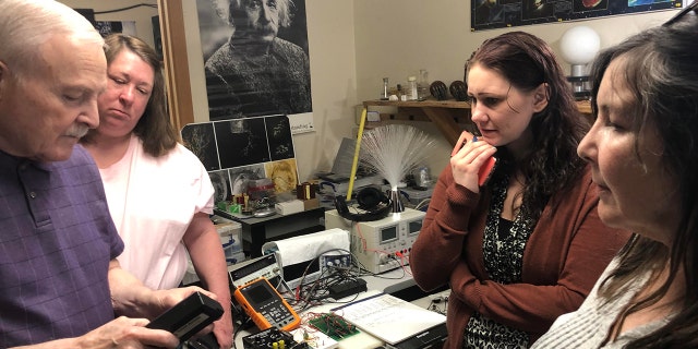 PI-NE team members are shown in a lab working on one of their cases. 