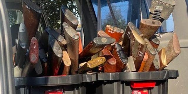 Dozens of shotguns and rifles sit in bins in the back of a car following Houston's gun buyback event.