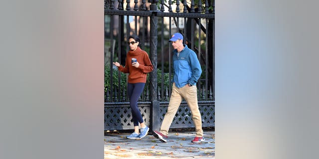 Huma Abedin wears sweater while out on a walk with her husband, wearing a blue jacket and baseball cap