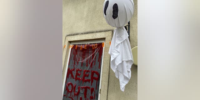 Faux warning signs that say "keep out" are a common Halloween decoration.