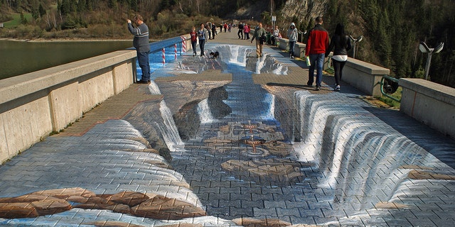 This painted walkway in the south of Poland makes it look as if you'd trip and fall into a crevasse if you were to attempt to walk straight across.