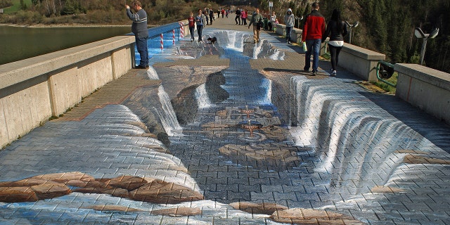 This painted walkway in the south of Poland makes it look as if you'd trip and fall into a crevasse if you were to attempt to walk straight across.